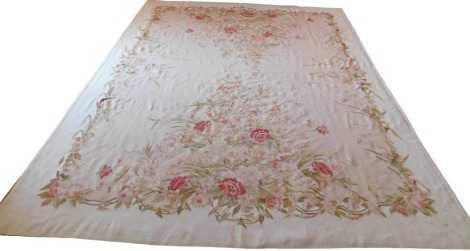 An Aubusson style rug, off white ground, decorated with pink flowers, leaves, etc, 300cm x 366cm.