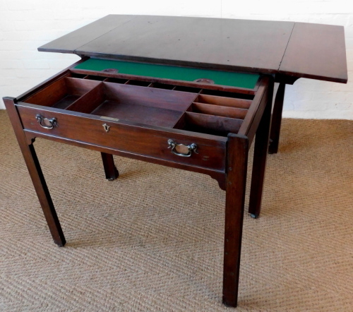 A George III mahogany architect's table, the rectangular top with drop leaves, with pull out front section of a false drawer with baize lined sliding interior revealing recesses on brass castors, 84cm high, 93cm wide, each drop leaf section 24cm, 66.5cm d