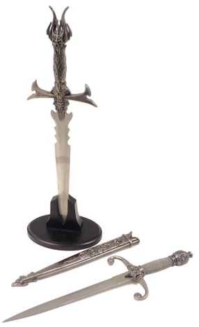 Two ornamental short swords or daggers, comprising one with acorn moulded handle and a reeded stem, 44cm long, and another on presentation stand, 50cm high. (2)