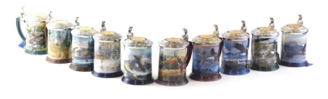 A set of ten Franklin Mint collectors tankards, each of differing form, to include Majestic Solitude, The Challenge of the Hunt, The Eagle of the Last Frontier, with silvered and gilt metal mounts, 15cm high.