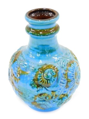 A German fat lava bottle shaped vase, decorated with shells, etc., in shades of blue, green and brown, 23cm high.