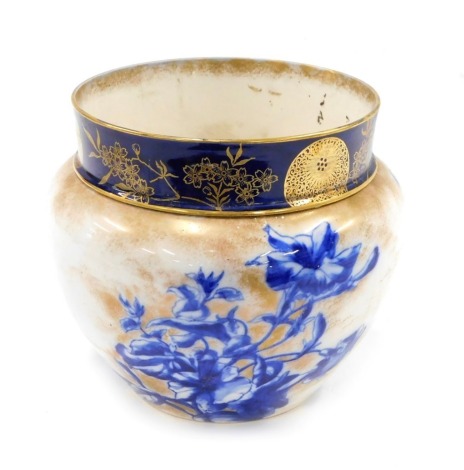 A Royal Doulton ceramic jardiniere, decorated in deep blue with flowers, etc., on a mottled gilt ground, and a matching drainer, 18cm high. (AF)