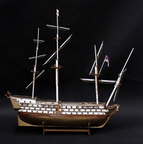 A scale model of HMS Victory, with three masts, various fitted cannon, part gilt metal hull, etc., 102cm long.