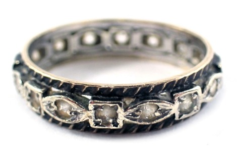 An eternity ring, set with white paste stones, in white and yellow metal believed to be 9ct gold and silver but unmarked, ring size N½, 3g.