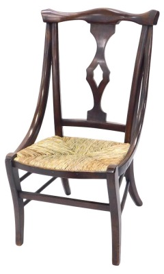 A late 19th/early 20thC country made side chair, with a pierced splat and a rush seat, on sabre legs.