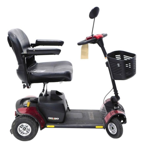 A Go-Go Elite Traveller Plus four wheel mobility scooter, with charger. WARNING! This lot contains untested or unsafe electrical items. It is supplied for scrap or re-conditioning only. TRADE ONLY