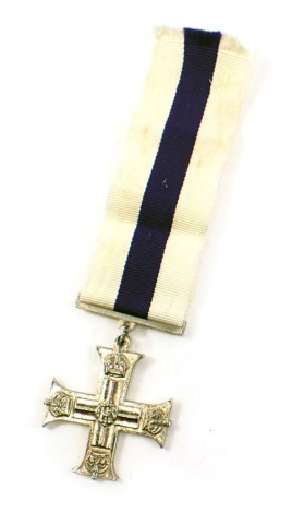 A replica base metal military cross, with modern ribbon.