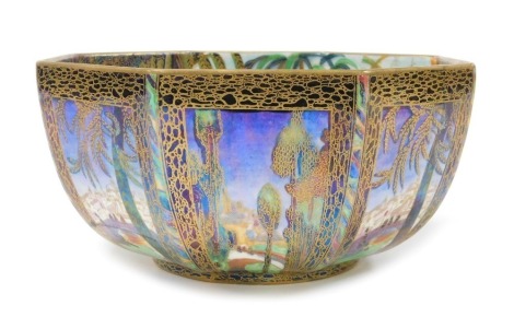 A Wedgwood Fairyland lustre octagonal bowl, designed by Daisy Makeig-Jones, pattern no. Z5125A, decorated internally with the Fairy In A Cage pattern, against a pearl lustre ground, externally with the Castle On The Road pattern, with a blue lustre ground