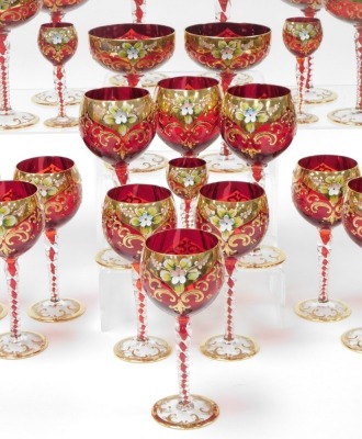 A mid 20thC Venetian ruby glass suite of table glassware, over decorated in enamel with flowers, gilt heightened, comprising thirteen champagne coupes, fourteen red wine and thirteen white wine glasses and eleven liqueur glasses. - 2