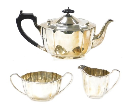 A George VI silver fluted three piece tea set, comprising teapot, cream jug and sugar bowl, Birmingham 1937, 34.03oz.