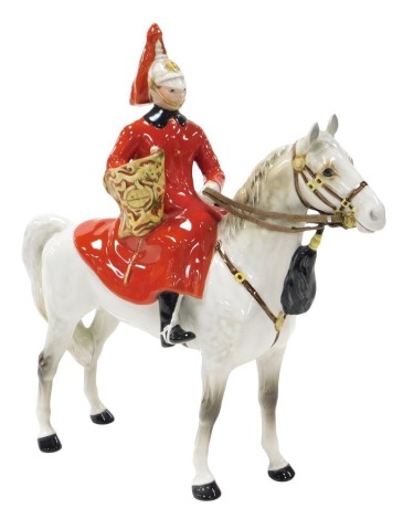 A Beswick pottery figure of a Lifeguard, mounted on a dappled grey horse, model number 1624, printed mark.