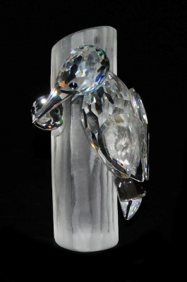 A pair of Swarovski crystal woodpeckers, modelled on ,and emerging from, a tree stump, 10cm high. - 2