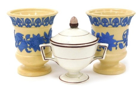 A pair of early 19thC Wedgwood cane ware vases, sprigged in blue with a band of convolvulus, beneath a band of acanthus leaves, impressed marks, 11cm high, together with a cream ware syllabub pot and cover, of twin handled form, the lid with an acorn fini