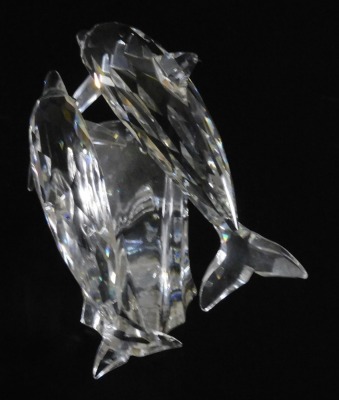 A pair of Swarovski crystal dolphins, modelled riding the crest of a wave, 12.5cm long. - 3