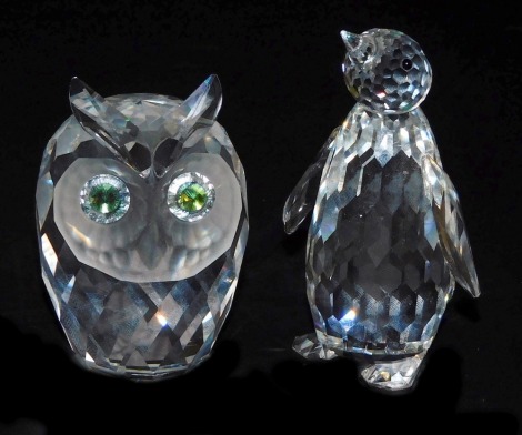 A Swarovski crystal figure of a penguin, 8.5cm high, together with an owl. (2)