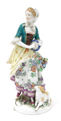 A late 19thC Samson porcelain figure, of a shepherdess, holding a tambourine, with a lamb at her feet, raised on a floral encrusted rococo base, gold anchor mark, 24cm high.