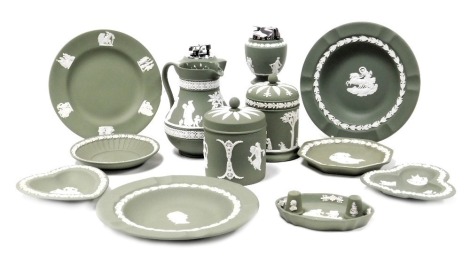 A group of Wedgwood green Jasperware, including jars and covers, table lighters, thimbles, plates and dishes. (a quantity)