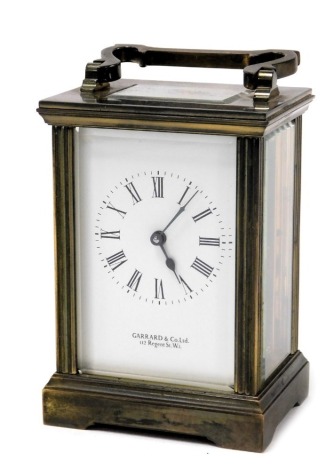 A Garrard & Company brass carriage clock, the rectangular dial bearing Roman numerals, single barrel movement, the case of conventional form, with presentation plaque verso, with key, 13cm high.