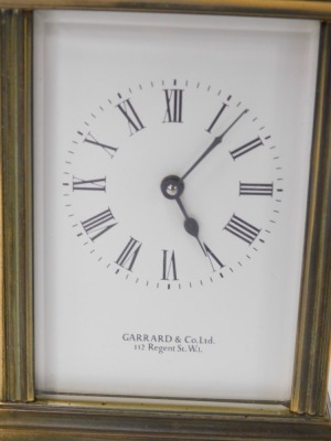 A Garrard & Company brass carriage clock, the rectangular dial bearing Roman numerals, single barrel movement, the case of conventional form, with presentation plaque verso, with key, 13cm high. - 2