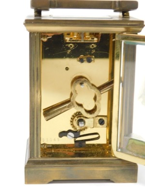 A Garrard & Company brass carriage clock, the rectangular dial bearing Roman numerals, single barrel movement, the case of conventional form, with presentation plaque verso, with key, 13cm high. - 3