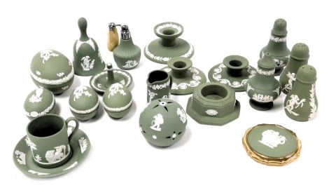 A group of Wedgwood green Jasperware, including a pair of Scotch candlesticks, a ring tree, condiments and sifters, pomander, atomiser, egg shaped boxes and a bell. (a quantity)