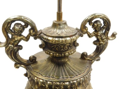 A late 20thC continental brass table lamp, of figural twin handled form, embossed with baroque motifs and foliage, on an integral plinth, 59.5cm high. - 2