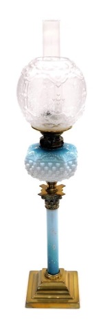 A late 19thC Young's duplex blue opalescent and brass oil lamp, of Corinthian column form decorated with flowers, with a basket moulded reservoir, on a stepped square base, together with a glass chimney and opaque and floral etched clear glass panelled sh