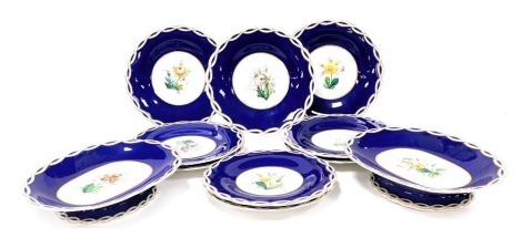 A late 19thC porcelain part dessert service, painted with flowers against a cobalt blue ground, bears impressed registration lozenge, pattern number A1353, painted marks, comprising pair of oval footed dishes and nine plates.