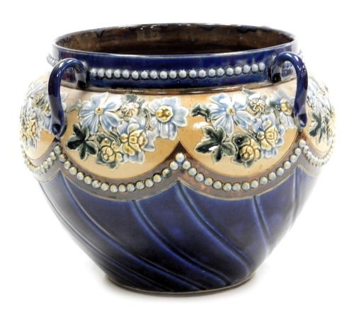 A late 19thC Doulton Lambeth stoneware jardiniere, of four handled semi fluted form, decorated with repeated sprays of flowers within beading, number 1672, impressed marks, 19cm high.