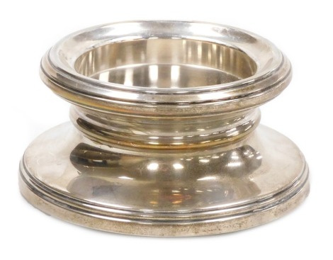 An Elizabeth II loaded silver desk stand, of plain, capstan form, Birmingham 2001, 13.88oz. 11.5cm diameter.