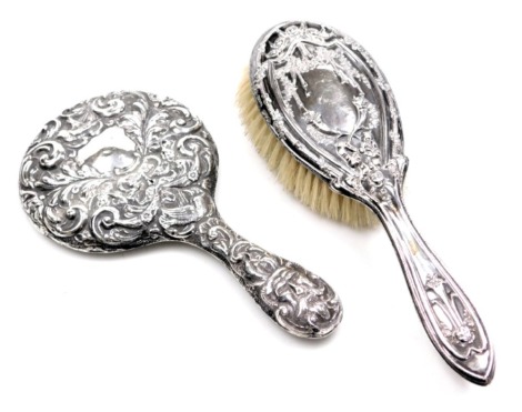 A George V silver backed hair brush, embossed with roses, cornucopia and floral drapes, Chester 1913, together with an Edward VII silver baked hand mirror, embossed with birds, masks and foliate scrolls, Birmingham 1903 (2, AF)