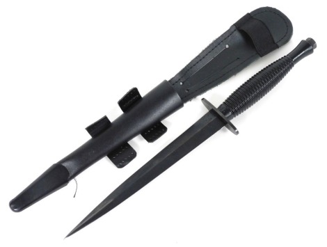 A Fairbairn-Sykes type fighting knife, with sheath, 30cm wide.