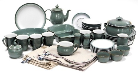 A Denby stoneware Regency Green pattern part dinner and tea service, comprising casserole dish and cover, twin division vegetable dish, oval dish, sauce boat on stand, six dinner and tea plates, six dessert bowls, three ramekins, salt and pepper, tea pot,