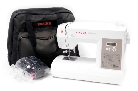 A Singer Brilliance electric sewing machine, model number 6180, serial number H16119M55516485, bagged with accessories.