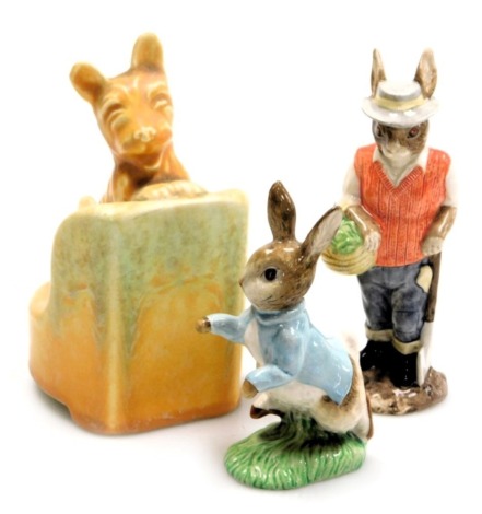 A Beswick Beatrix Potter figure of Peter Rabbit, brown back stamp, together with a figure of Gardener Rabbit, and a Beswick Pottery bookend, modelled as a Scottie dog on a chair. (3)