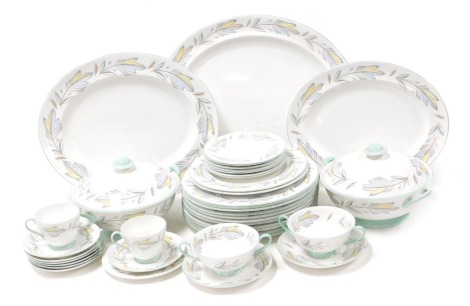 A Shelley porcelain Caprice pattern part dinner and tea service, comprising three graduated meat platters, pair of vegetable tureens and covers, eleven dinner and two dessert plates, two soup cups and saucers, two tea cups, seven saucers and side plates.