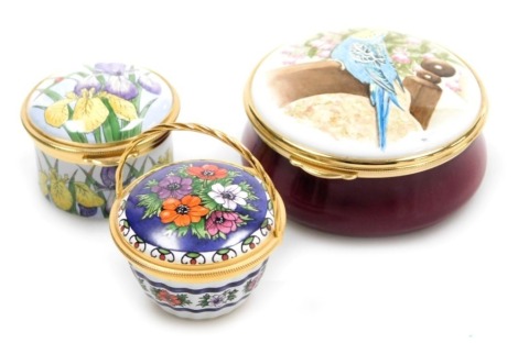 Two Staffordshire enamel boxes, one decorated with a budgerigar, the other with irises, together with an enamel basket decorated with flowers, all boxed with certificates. (3)