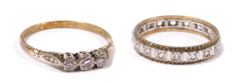 A diamond three stone ring, in a high claw illusion setting, marked 9ct and plat, size T, and a white stone set full eternity ring, in yellow and white metal, marked 9ct, size O, 4.0g.