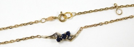 A 9ct gold, sapphire and clear stone bracelet, in a cross over design, on a cable link chain with bolt ring clasp, 2.2g.