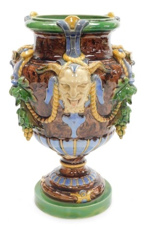 A late 19thC Minton majolica vase, of baluster form, moulded with Bacchanalian masks, vines and rope swags, impressed marks, 32.5cm high. (AF)