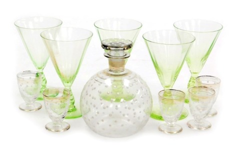 An early 20thC continental glass liqueur set, with a decanter decorated with white enamelled jewelling, and five glasses, together with five early 20thC continental green glass wine glasses.