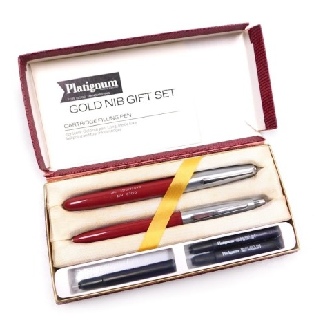 A Platignum red ball point and cartridge pen set, with cartridges, boxed.