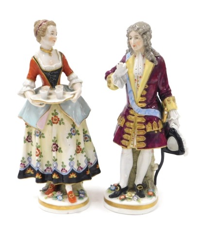 A pair of late 19thC Vienna style porcelain figures, of a gallant, and a lady offering refreshments on a tray, raised on naturalistic bases, 23cm high. (AF)