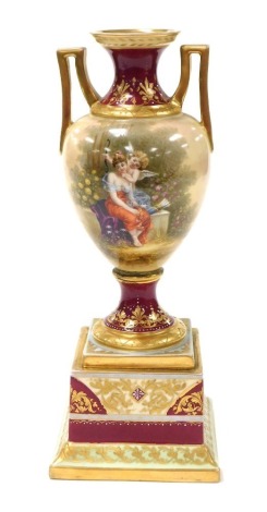 A 19thC Vienna porcelain vase, of twin handled baluster form, raised on a plinth base, painted by Bernard, with a classical figure being attended to by Cupid, verso Cupid and a cherub, titled to base "SeIgut", number 3208, 26cm high. (AF)