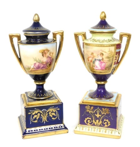 A 19thC Vienna style porcelain vase and cover, on a plinth base, reserve decorated by C.H. Heer, with a classical scene, against a purple, burgundy and yellow ground, gilt heightened, 21cm high, and a further vase and cover, of similar form, decorated wit