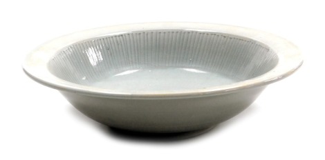 A Chinese celadon porcelain bowl, with incised lines to the internal sides, 28cm diameter.