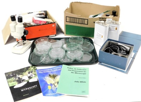 A compound microscope case, microscope, petri dishes, assorted tools, cased, syringes, liquids and microscopy booklets. (a quantity)