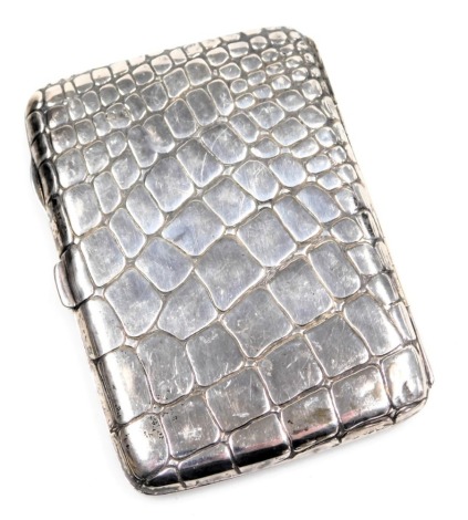 An early 20thC silver cigarette case, of simulated crocodile skin form, hallmarks rubbed, 2.01oz, 11cm high.