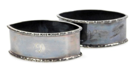 A pair of George V silver napkin rings, of rhomboid form, initial engraved, Birmingham 1927, 2.48oz.