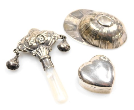 A silver caddy spoon modelled as a jockey's cap, Victorian silver pill box, of heart shaped form, Sydney & Co, Birmingham 1900, and a silver and mother of pearl baby's rattle and teether, 102oz all in (3)